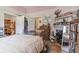 This bedroom has hardwood floors, lots of books, a closet, and a fireplace at 782 Marion Se Ave, Atlanta, GA 30312