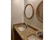 Elegant bathroom vanity with double sinks, granite countertop, and stylish round mirrors, unfinished faucet installs at 1167 Oakland Sw Dr, Atlanta, GA 30310