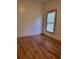 Bedroom with hardwood floors, neutral walls, and a window, creating a bright and welcoming atmosphere at 1167 Oakland Sw Dr, Atlanta, GA 30310