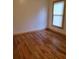 Bedroom with hardwood floors, neutral walls, and a window, offering a serene and comfortable retreat at 1167 Oakland Sw Dr, Atlanta, GA 30310