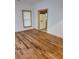 Living room with gleaming hardwood floors, bright natural light, and an inviting open doorway to the kitchen at 1167 Oakland Sw Dr, Atlanta, GA 30310
