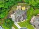 Aerial view of a landscaped property with a backyard patio, manicured lawn, and lush greenery at 1575 Petal Nw Pt, Kennesaw, GA 30152