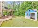 Spacious backyard featuring a playhouse, patio, and deck with stairs at 1575 Petal Nw Pt, Kennesaw, GA 30152