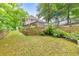 Lush backyard with tiered landscaping and a view of the home's exterior at 1575 Petal Nw Pt, Kennesaw, GA 30152