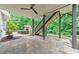 Outdoor patio area with an exterior staircase and a stone fireplace in a wooded area at 1575 Petal Nw Pt, Kennesaw, GA 30152