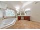 Bathroom features tile floors, soaking tub, dual vanities and lots of counter space at 1575 Petal Nw Pt, Kennesaw, GA 30152