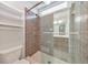 Tiled shower enclosure with glass door and built-in shelves, complemented by neutral walls and fixtures at 1575 Petal Nw Pt, Kennesaw, GA 30152
