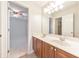 Well-lit bathroom features double sinks, wood cabinets and large mirror at 1575 Petal Nw Pt, Kennesaw, GA 30152