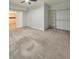 Spacious bedroom with neutral carpet, ceiling fan, closet, and a door leading to the closet at 1575 Petal Nw Pt, Kennesaw, GA 30152