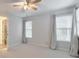 Spacious bedroom features neutral carpet and walls, enhanced by natural light from large windows at 1575 Petal Nw Pt, Kennesaw, GA 30152