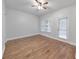 Bright bedroom features hardwood floors, neutral walls, a ceiling fan, and a window at 1575 Petal Nw Pt, Kennesaw, GA 30152