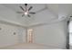 Bedroom featuring trey ceiling, ceiling fan, and two closets that flank a bathroom at 1575 Petal Nw Pt, Kennesaw, GA 30152