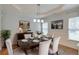 Classic dining room with hardwood floors, wainscoting, and a modern light fixture at 1575 Petal Nw Pt, Kennesaw, GA 30152