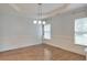 Bright dining room featuring hardwood floors, wainscoting, and modern light fixture at 1575 Petal Nw Pt, Kennesaw, GA 30152