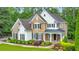 Exterior of a two-story home with a manicured lawn and stone accents at 1575 Petal Nw Pt, Kennesaw, GA 30152