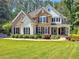 Beautiful two-story home with brick and stone accents, surrounded by lush landscaping at 1575 Petal Nw Pt, Kennesaw, GA 30152