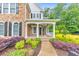 Charming front porch with stone accents, landscaping, and a brick walkway at 1575 Petal Nw Pt, Kennesaw, GA 30152