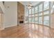 Spacious living room with hardwood floors, stone fireplace, and large windows at 1575 Petal Nw Pt, Kennesaw, GA 30152