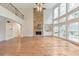 Bright living area with hardwood floors, fireplace, and floor to ceiling windows at 1575 Petal Nw Pt, Kennesaw, GA 30152