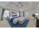Spacious main bedroom with tray ceiling, neutral decor, and a comfortable seating area at 1575 Petal Nw Pt, Kennesaw, GA 30152