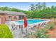 Community pool area with lounge chairs, tables, umbrellas, and landscaped surroundings at 1575 Petal Nw Pt, Kennesaw, GA 30152