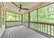 Inviting screened-in porch with ceiling fan and wood floors offers a relaxing outdoor space at 1575 Petal Nw Pt, Kennesaw, GA 30152