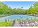 Well-maintained community tennis courts with spectator seating and surrounding greenery at 1575 Petal Nw Pt, Kennesaw, GA 30152