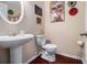 Stylish powder room featuring a pedestal sink, elegant decor, and hardwood flooring at 2555 Flat Shoals Rd # 1405, Atlanta, GA 30349