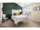 Inviting bedroom featuring a statement wall, a plush carpet, and an abundance of natural light from the window at 2555 Flat Shoals Rd # 1405, Atlanta, GA 30349