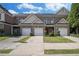 Well-kept townhomes showcasing individual one-car garages and manicured lawns in a tidy neighborhood setting at 2555 Flat Shoals Rd # 1405, Atlanta, GA 30349
