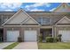Charming brick townhome featuring a one-car garage and well-maintained landscaping, inviting curb appeal at 2555 Flat Shoals Rd # 1405, Atlanta, GA 30349