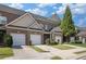 A row of brick townhomes, each with a one-car garage and neatly trimmed green spaces, offering a sense of community at 2555 Flat Shoals Rd # 1405, Atlanta, GA 30349