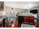 Open concept kitchen features dark cabinets, hardwood floors, and a dining area creating a functional and stylish space at 2555 Flat Shoals Rd # 1405, Atlanta, GA 30349