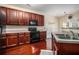 Functional kitchen equipped with dark wood cabinets, black appliances, and hardwood floors, offering a practical cooking space at 2555 Flat Shoals Rd # 1405, Atlanta, GA 30349