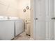 Convenient laundry room with washer, dryer, wire shelving, and extra storage at 2555 Flat Shoals Rd # 1405, Atlanta, GA 30349