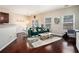 Cozy living room with hardwood floors, a comfortable green sofa, and natural light creating a welcoming atmosphere at 2555 Flat Shoals Rd # 1405, Atlanta, GA 30349
