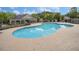 Community pool surrounded by a sundeck and lush greenery for a refreshing outdoor experience at 2555 Flat Shoals Rd # 1405, Atlanta, GA 30349