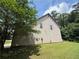 Picture of the side of a two story house with a small tree and green lawn at 381 Plymstock Dr, Mcdonough, GA 30253