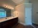 Bathroom featuring dual sinks with dark wood cabinets and a large mirror at 381 Plymstock Dr, Mcdonough, GA 30253