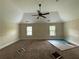 Large bedroom featuring a ceiling fan, two windows, and neutral carpeting at 381 Plymstock Dr, Mcdonough, GA 30253