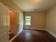 Cozy bedroom with hardwood floors, a window, and a neutral color scheme at 381 Plymstock Dr, Mcdonough, GA 30253