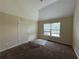 Bedroom with a vaulted ceiling, large window, and neutral walls at 381 Plymstock Dr, Mcdonough, GA 30253