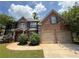 Charming brick home with a two-car garage, manicured lawn, and beautiful landscaping at 381 Plymstock Dr, Mcdonough, GA 30253