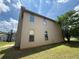 Exterior angle of two story house with a well manicured lawn and mature shade tree at 381 Plymstock Dr, Mcdonough, GA 30253
