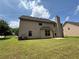 Side view of home highlighting lawn, patio area and lush landscaping at 381 Plymstock Dr, Mcdonough, GA 30253