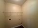 A small, empty laundry room with a wire shelf and outlets, ready to be equipped at 381 Plymstock Dr, Mcdonough, GA 30253