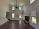 Inviting living room with a fireplace, soaring ceilings, and abundant natural light at 381 Plymstock Dr, Mcdonough, GA 30253
