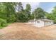 Scenic backyard of the home with spacious lawn area and mature trees at 703 Alvis Ln, Norcross, GA 30093