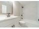 This bathroom features marble tile, updated fixtures and white vanity at 703 Alvis Ln, Norcross, GA 30093