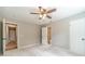 This bedroom features neutral paint, ceiling fan and adjacent bathroom at 703 Alvis Ln, Norcross, GA 30093
